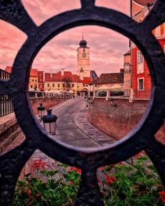a view of a city through a metal window at Pensiunea Cardinal in Sibiu