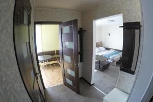a room with a bedroom with a bed and a mirror at Уютная квартира со свежим ремонтом in Odesa
