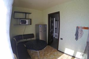 a small kitchen with a table and a refrigerator at Уютная квартира со свежим ремонтом in Odesa