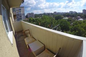 a chair and a desk on a balcony at Уютная квартира со свежим ремонтом in Odesa