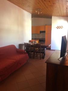 a living room with a kitchen and a dining room at Casetta Mondello in Mondello