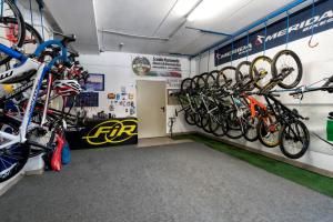 a bike shop with a bunch of bikes on the wall at Albergo Panorama in Panchia