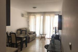 a living room with a couch and a table at Комфортное жильё в 250 метрах от моря ! in Sveti Vlas