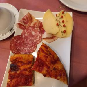 a plate of food with slices of pizza and other foods at B&B Stupor Mundi in Altamura