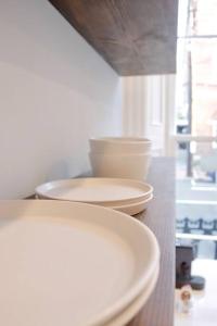 two plates and bowls sitting on top of a counter at The Duke Suite at Prince Street Inn in Alexandria