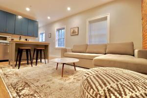 a living room with a couch and a table at The Fairfax Suite at Prince Street Inn in Alexandria