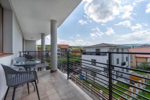 a balcony with a table and chairs and a view at Urbio Private Suites in Cluj-Napoca