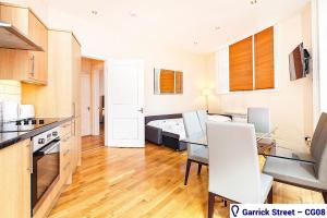 a kitchen and dining room with a table and chairs at Stayo Covent Garden in London