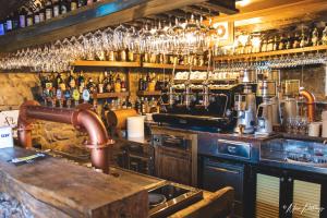 a kitchen with a bar with a lot of alcohol at Da Castruccio degli Antelminelli in Coreglia Antelminelli