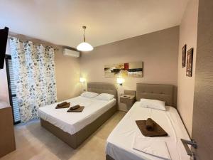 Postel nebo postele na pokoji v ubytování SEA VIEW APARTMENTS Aphrodite