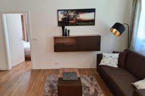 a living room with a couch and a table at Apartmány NETA Velké Karlovice, Polanský Dvůr in Velké Karlovice