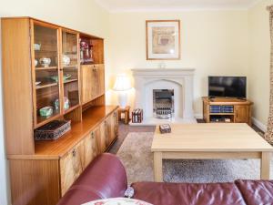 a living room with a couch and a table at The Nook 285B in Colwyn Bay