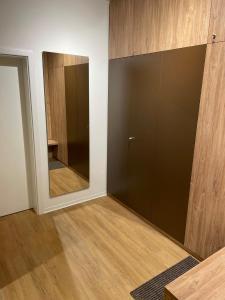 a room with a large glass closet with a mirror at Apartmány NETA Velké Karlovice, Polanský Dvůr in Velké Karlovice