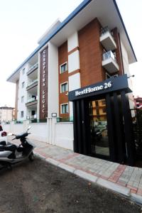 a scooter parked in front of a building at Апартаменты Best Home 26 Cleopatra Legacy No 8 in Alanya
