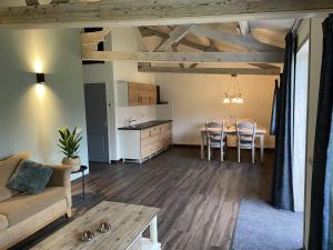 a living room with a couch and a table at De Dennen in Odoorn
