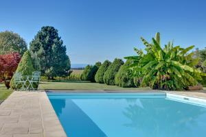 a swimming pool in a yard with trees and bushes at L'Atelier 4 stars Luxury, Hot Tub, Pool in Nambsheim