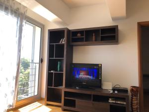 a living room with a flat screen tv on a entertainment center at Apartment Marina in Bar