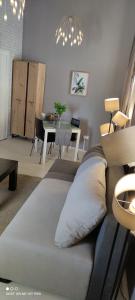 a living room with a couch and a dining room at Inbox Apartments in Bitola
