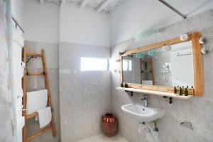 a bathroom with a sink and a mirror at Archipelagos Kimolos in Kimolos +19 photos