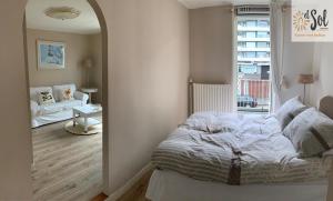 a bedroom with a bed and a large window at El Sol Zandvoort in Zandvoort