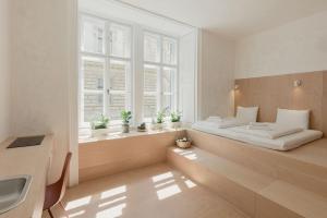 a bedroom with a bed and a window at Flow Spaces in Budapest