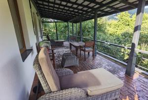 a screened in porch with a table and chairs at vila zia in Corbeni