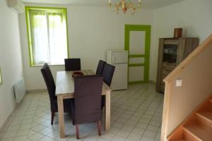uma cozinha com mesa e cadeiras num quarto em Gite de Bossican em Montmartin-le-Haut
