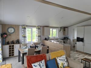 a kitchen and living room with a table and chairs at Mawgan Pads Mawgan Porth in Mawgan Porth