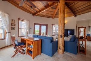 uma sala de estar com um sofá azul e uma mesa em Indigo Belize 2B Condo em San Pedro