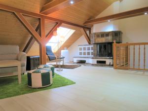 a living room with a couch and a stove at Penthouse Wolkenstein großzügige Maisonette auf 155 qm mit Whirlpool, Klima & Kamin in Senftenberg