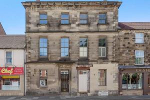an old stone building on the corner of a street at The Oldgate in Morpeth