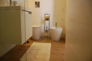 a bathroom with a sink and a toilet and a mirror at Profumo Di Gelsomino in Scicli +22 photos