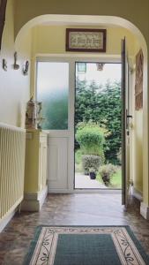 a hallway with an open door to a yard at Cub Cottage in Kilcoo