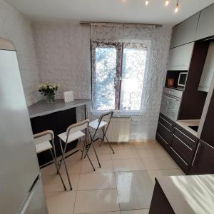 a kitchen with a table and chairs in a room at Apartament Centrum in Wieliczka