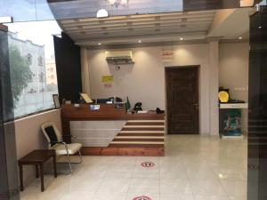 a lobby with a cash register and a door at Al Samia apartment in Baljurashi