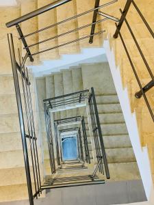a staircase in a building with metal railings at Hotel VIU57 in Mellieħa