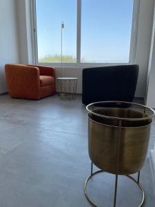 a living room with a couch and a chair at Hotel VIU57 in Mellieħa
