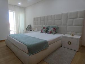 Villa Barrinha tesisinde bir odada yatak veya yataklar