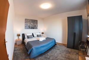a bedroom with a large bed with a blue blanket at Seaview Villa Summer with private pool & garden in Rtina +76 photos