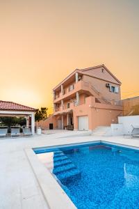 a villa with a swimming pool and a house at Villa Summer in Rtina
