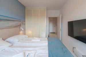 Łóżko lub łóżka w pokoju w obiekcie Mi Casa Holidays Apartamenty Olimpijska O2