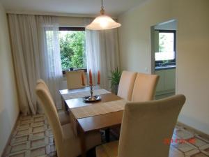 a dining room with a wooden table and chairs at Appartement-Heuberg in Salzburg +56 photos