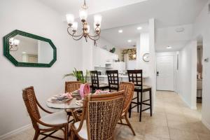 a dining room with a table and chairs and a mirror at Royal Palm 203 in Marco Island