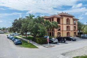 a large building with cars parked in a parking lot at Royal Palm 203 in Marco Island