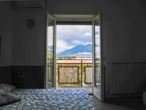 a bedroom with a bed and a view of a mountain at Avezzano 3e60 in Avezzano