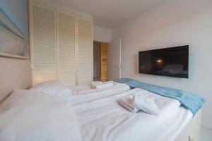 Łóżko lub łóżka w pokoju w obiekcie Mi Casa Holidays Apartamenty Olimpijska O2