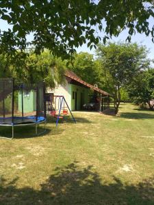 a yard with a playground with a house at Vikendica Budžak 51 - Apatin in Apatin
