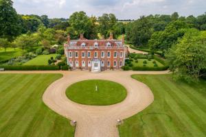 an aerial view of a large house with a large yard at Stylish luxury cottage in historic country estate - Belchamp Hall Coach House in Sudbury