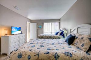 a bedroom with a bed and a television in it at Bay Oaks C 2nd Floor in Siesta Key +42 photos