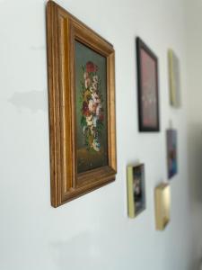 a painting of flowers on a white wall at Bed & Beach Amsterdam in Amsterdam